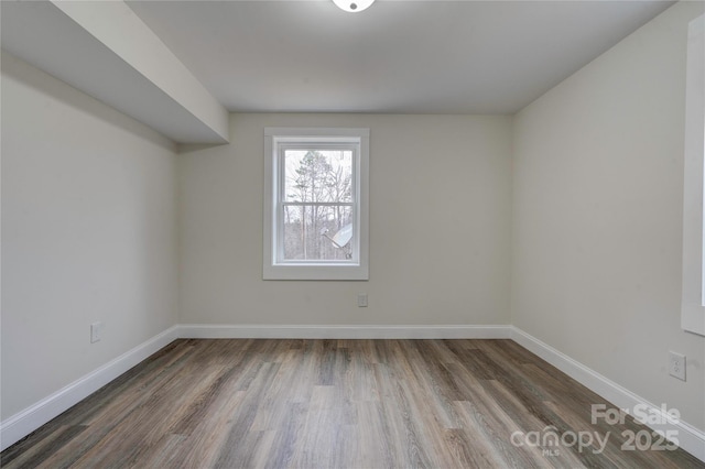 spare room featuring dark wood-type flooring