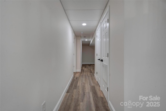 corridor with hardwood / wood-style floors