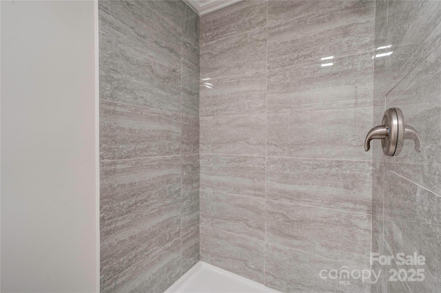 bathroom with a tile shower