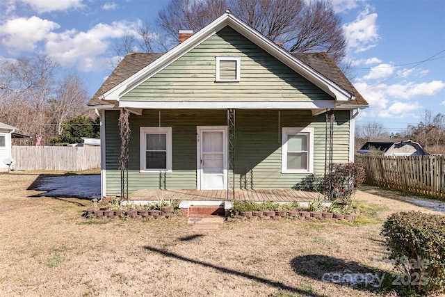 bungalow-style home featuring a front yard