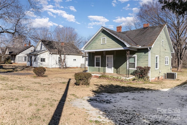 bungalow-style house with a porch and central air condition unit