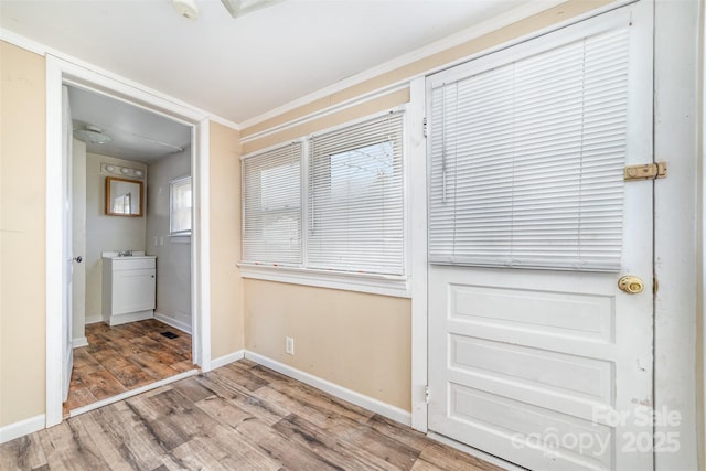 unfurnished bedroom featuring wood-type flooring and ornamental molding