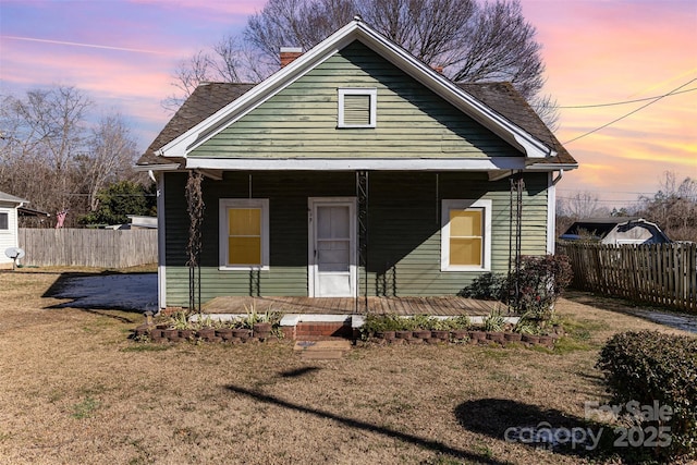 bungalow-style home with a lawn