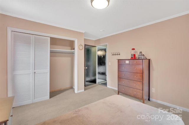 carpeted bedroom with a closet, baseboards, and ornamental molding