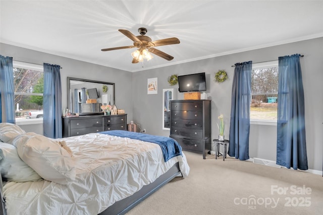 bedroom with crown molding, carpet flooring, and ceiling fan