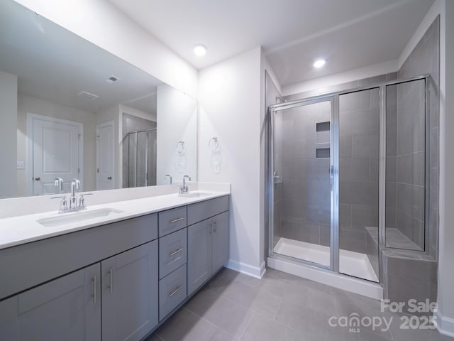 bathroom with tile patterned floors, an enclosed shower, and vanity