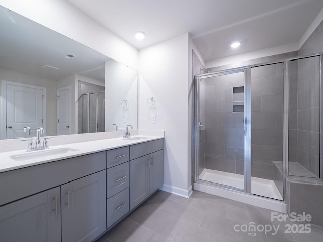 bathroom with vanity, tile patterned floors, and a shower with shower door