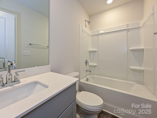 full bathroom featuring toilet, vanity, and washtub / shower combination