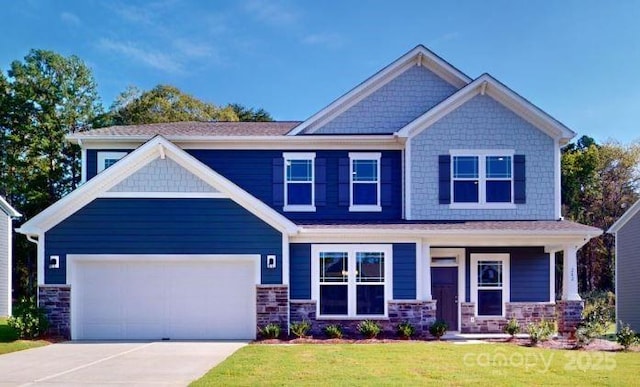 craftsman house with a garage and a front yard