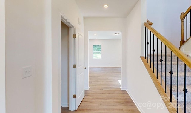 corridor with light wood-type flooring