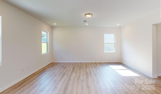 unfurnished room featuring light hardwood / wood-style flooring and a wealth of natural light