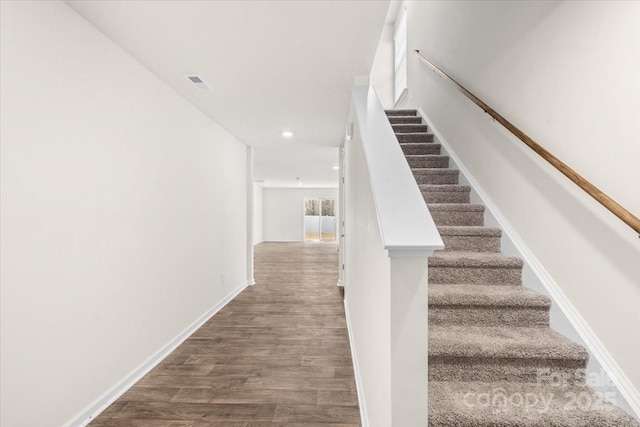 stairway with hardwood / wood-style floors