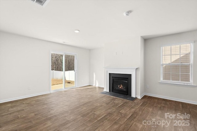 unfurnished living room featuring dark hardwood / wood-style flooring