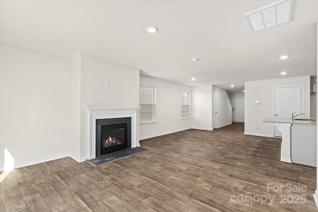 unfurnished living room with dark wood-type flooring