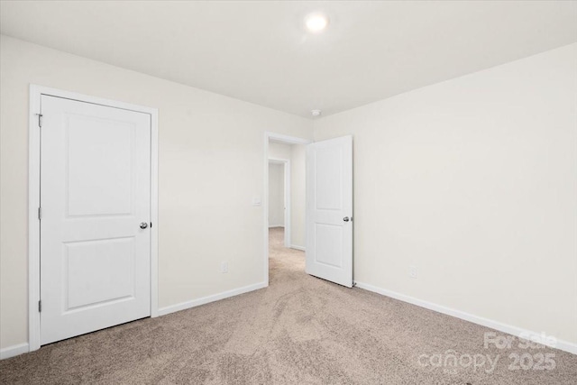 unfurnished room with light colored carpet