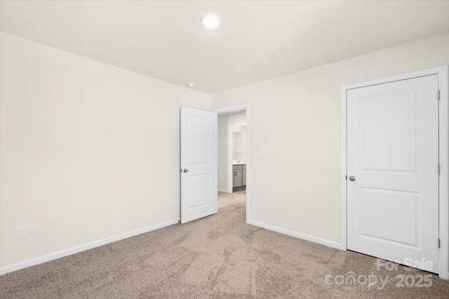 unfurnished bedroom featuring light colored carpet