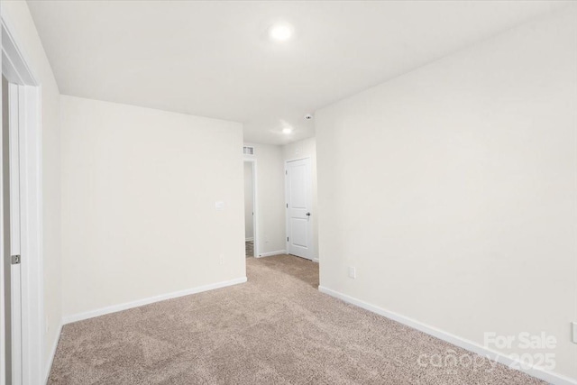 spare room with light colored carpet