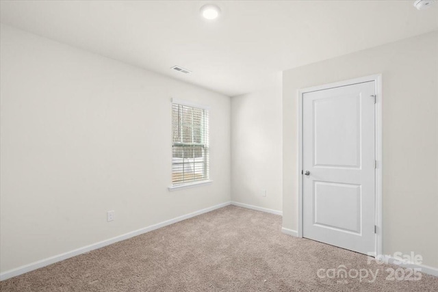 spare room with light colored carpet