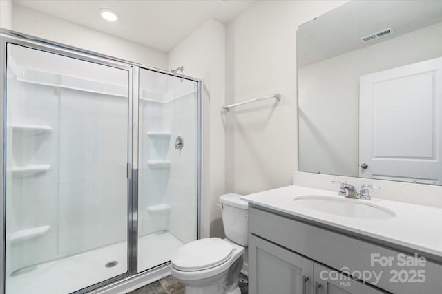 bathroom with a shower with door, toilet, and vanity