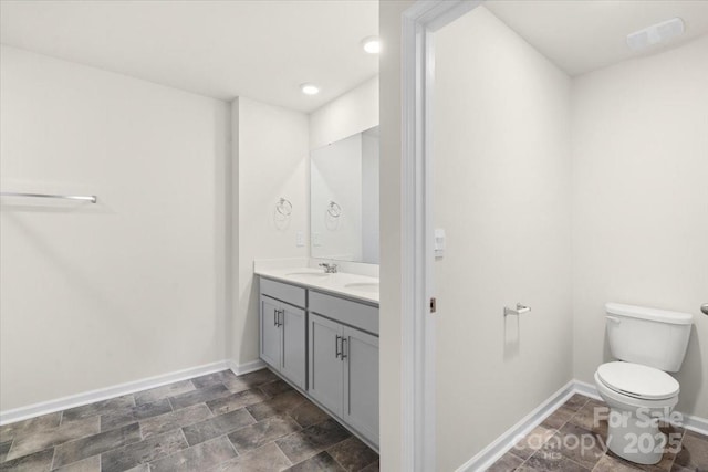 bathroom with toilet and vanity