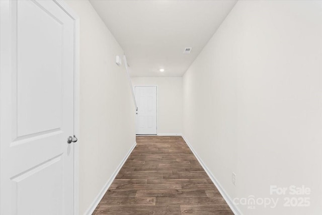 corridor featuring dark hardwood / wood-style flooring