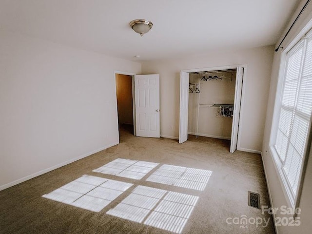 unfurnished bedroom with carpet floors and a closet