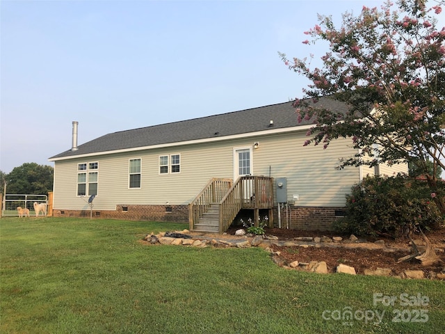 rear view of property with a lawn