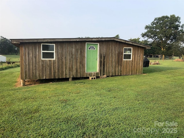 view of outbuilding featuring a lawn