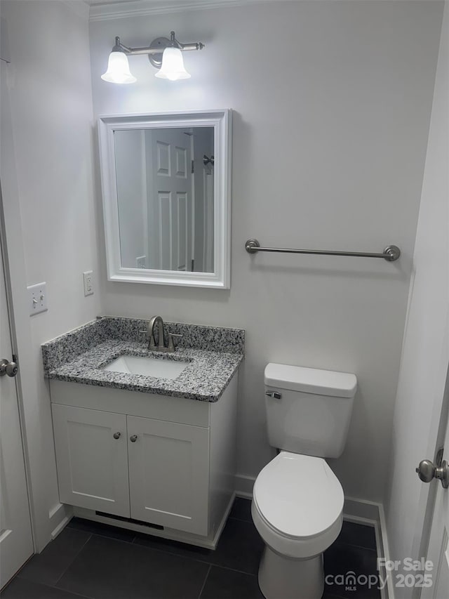 bathroom with tile patterned flooring, vanity, and toilet