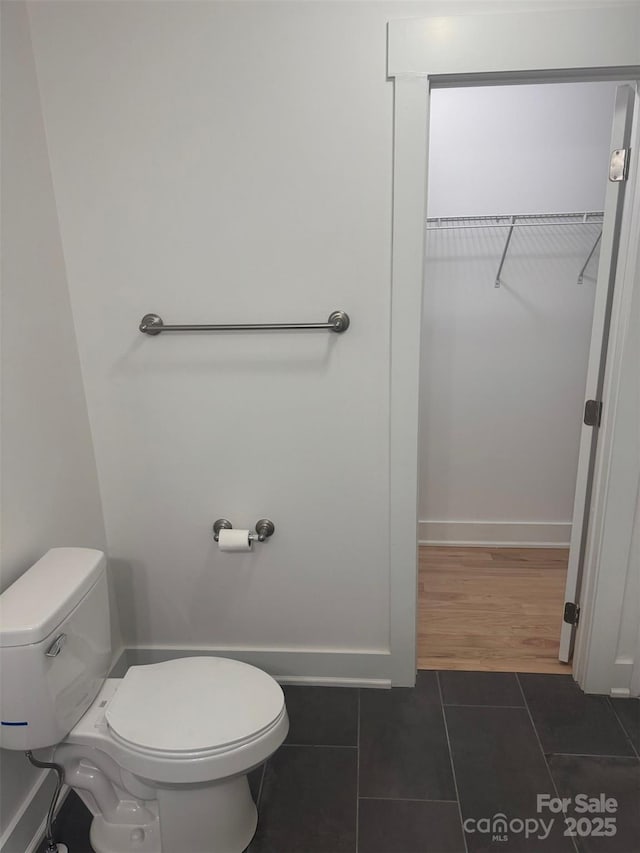 bathroom featuring tile patterned floors and toilet