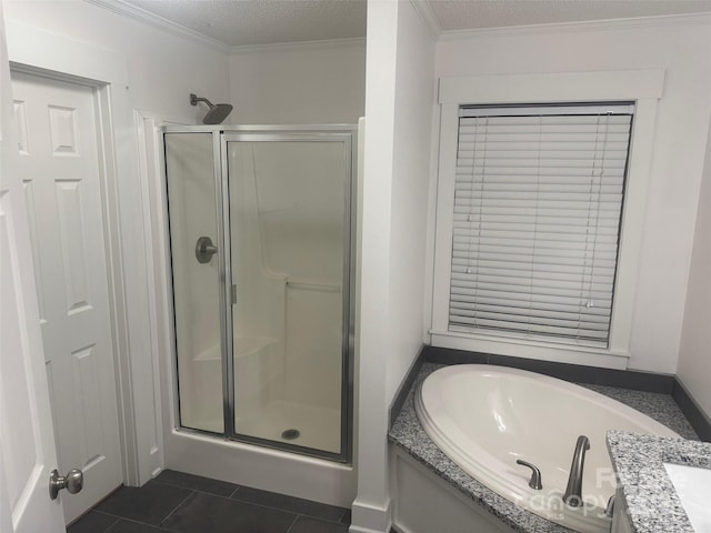 bathroom featuring vanity, a textured ceiling, crown molding, plus walk in shower, and tile patterned flooring