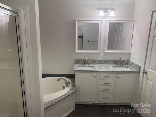 bathroom with crown molding, tile patterned flooring, vanity, and a washtub