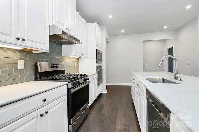 kitchen featuring light stone countertops, sink, dark hardwood / wood-style flooring, white cabinets, and appliances with stainless steel finishes