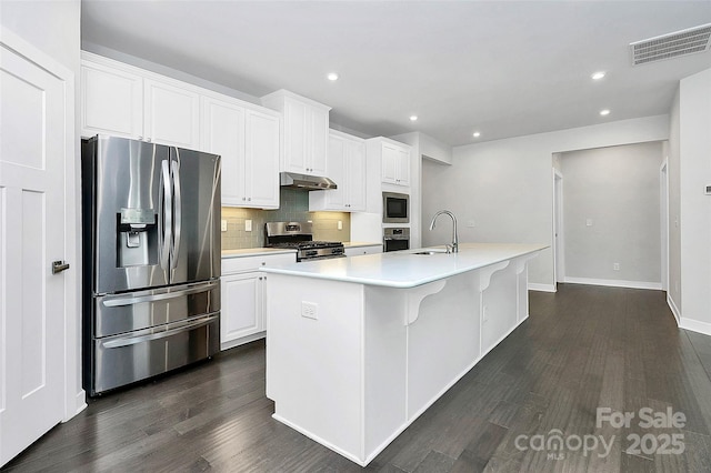 kitchen featuring sink, white cabinetry, an island with sink, and appliances with stainless steel finishes