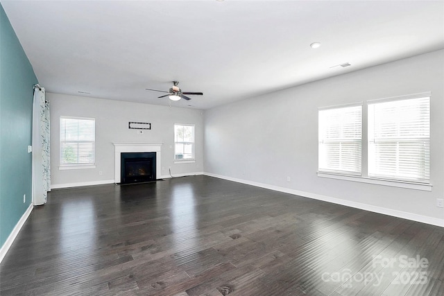 unfurnished living room featuring ceiling fan and dark hardwood / wood-style floors