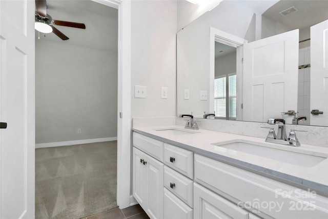 bathroom with tile patterned floors, vanity, and ceiling fan