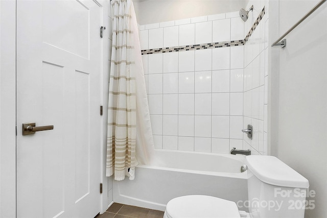 bathroom with tile patterned floors, shower / bath combination with curtain, and toilet