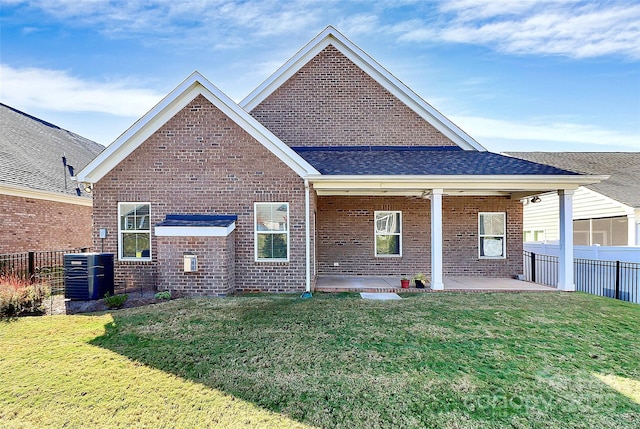 back of property featuring a yard, a patio, and central AC