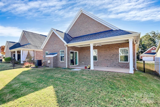 rear view of property featuring central AC, a yard, and a patio