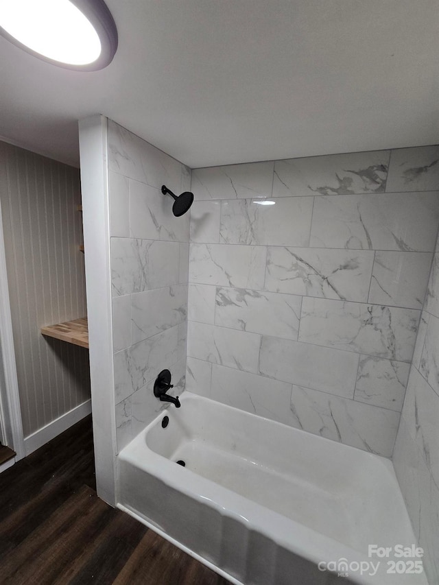 bathroom with tiled shower / bath combo and hardwood / wood-style floors