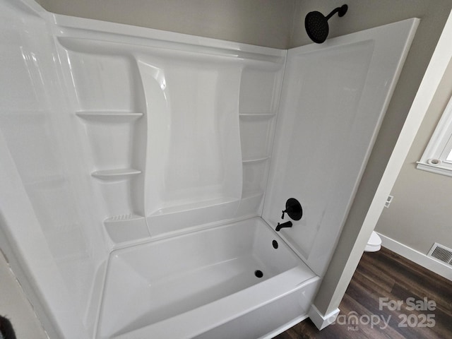 bathroom featuring hardwood / wood-style floors and shower / bathing tub combination