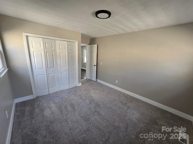 unfurnished bedroom featuring a closet and carpet