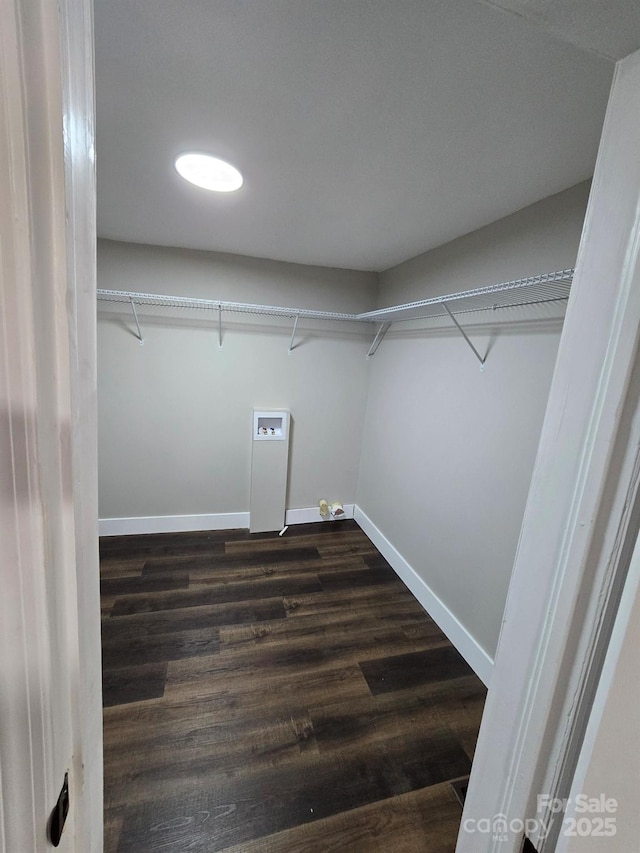 clothes washing area with dark hardwood / wood-style flooring and washer hookup