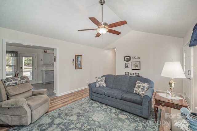 living room with ceiling fan, lofted ceiling, and wood-type flooring