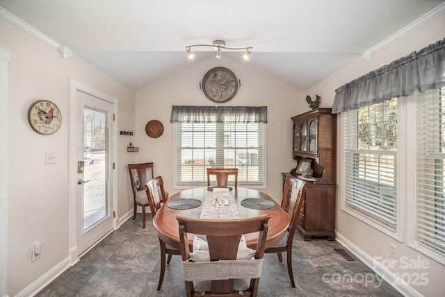 dining space with a wealth of natural light and lofted ceiling