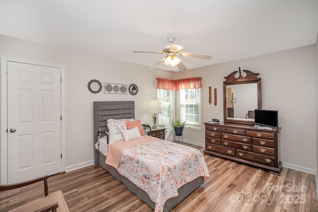 bedroom with ceiling fan and hardwood / wood-style flooring