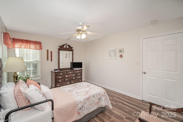 bedroom featuring ceiling fan and dark hardwood / wood-style flooring