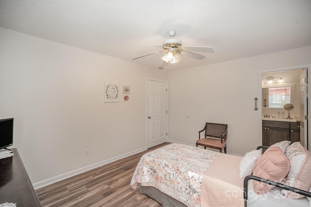 bedroom with ceiling fan, dark hardwood / wood-style floors, and ensuite bathroom