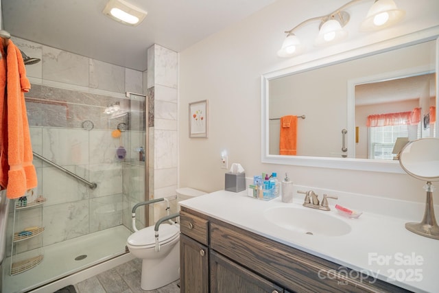 bathroom with an enclosed shower, vanity, and toilet