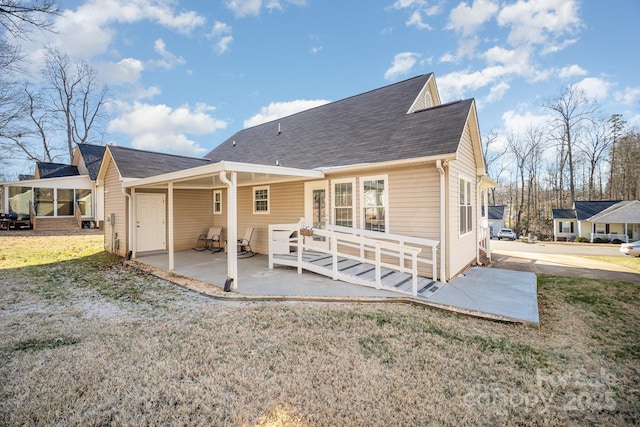 back of house featuring a patio area and a yard